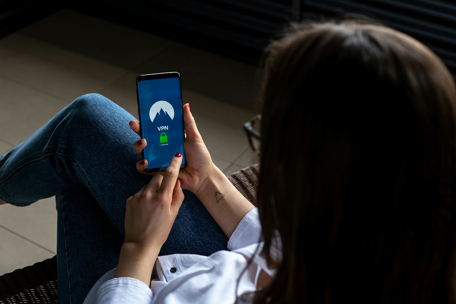 A frontline worker checking a message on her phone